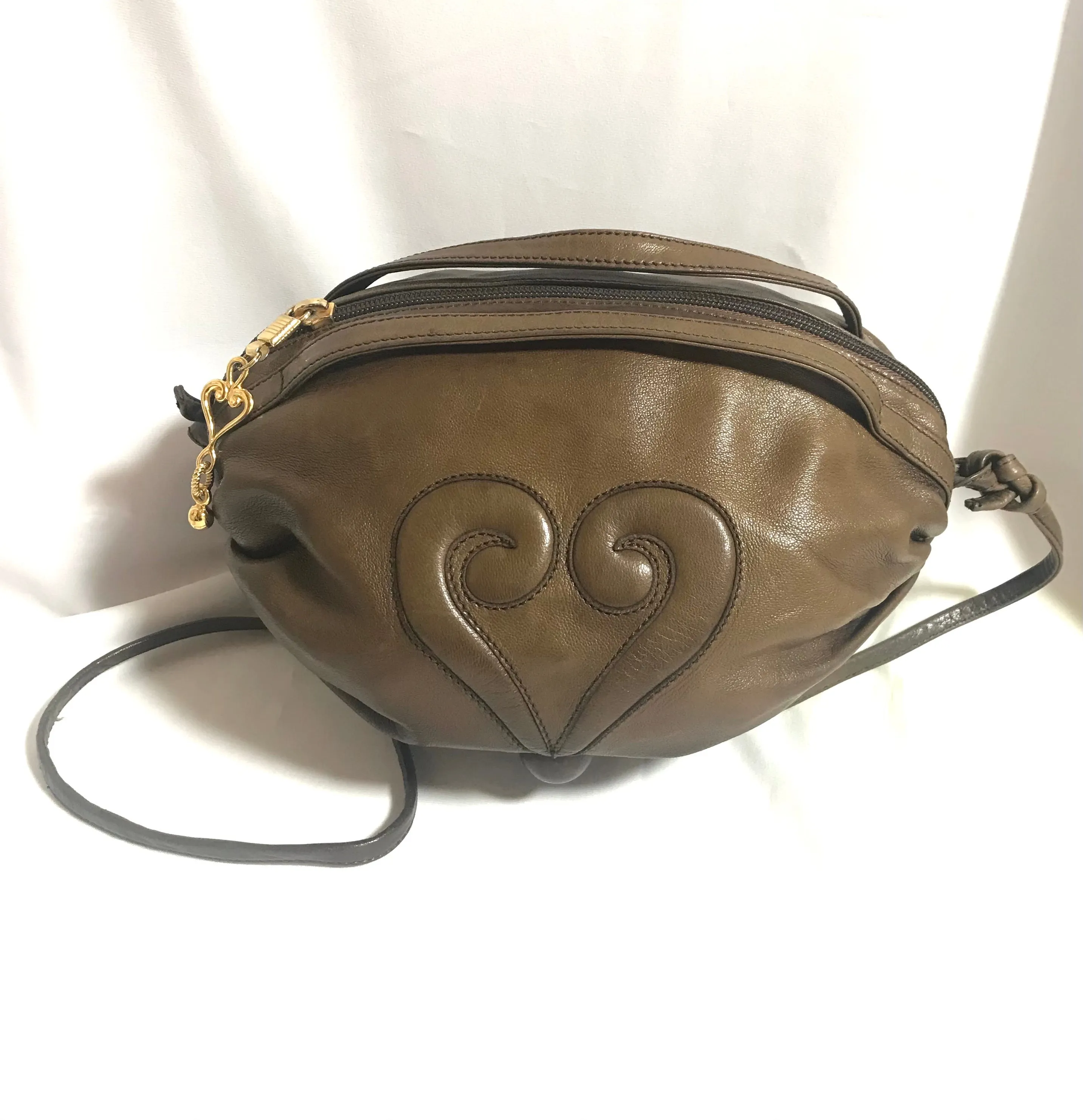 Vintage Moschino soft brown leather drum shape shoulder bag with iconic Question marks. Moschino by Redwall. Made in Italy. 060724r1 Moschino by Redwall. Made in Italy.